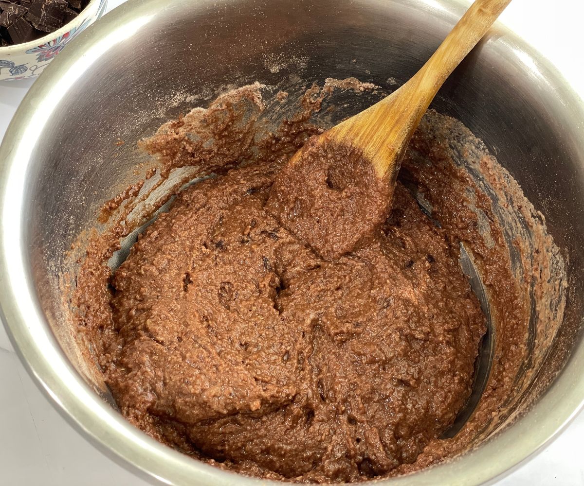 A bowl has vegan brownie wet mix.